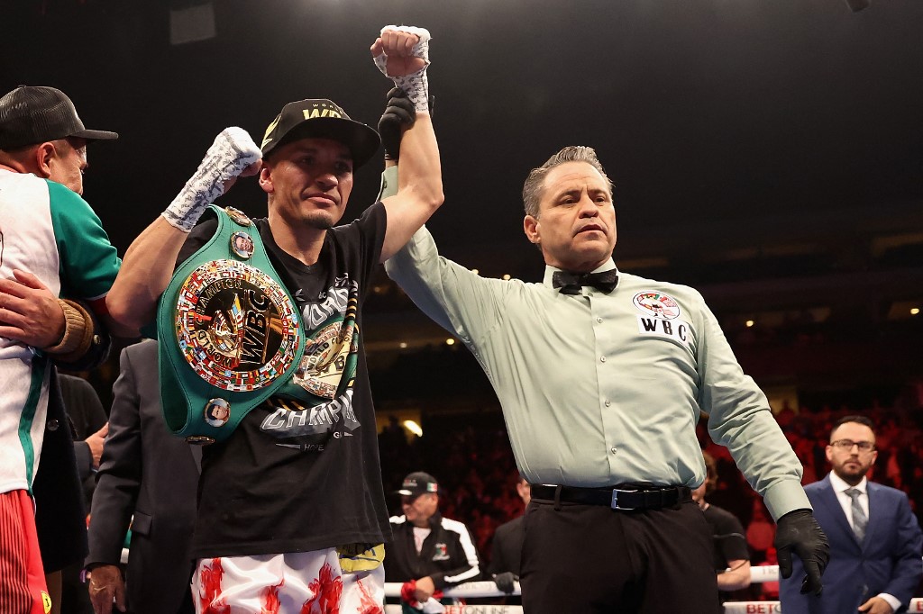 Juan Francisco Estrada of Mexico celebrates his victory by majority decision over Roman Gonzalez of Nicaragua during their WBC super flyweight title bout at Desert Diamond Arena on December 03, 2022 in Glendale, Arizona. 