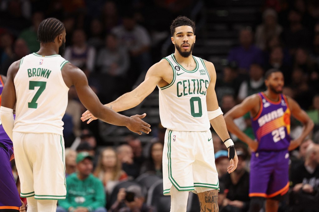     Jayson Tatum #0 of the Boston Celtics hits high Jaylen Brown #7 after scoring against the Phoenix Suns during the second half of an NBA game at Footprint Center on December 7, 2022 in Phoenix, Arizona. 