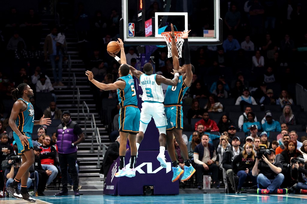 Terry Rozier #3 of the Charlotte Hornets has his shot blocked by Alec Burks #5 of the Detroit Pistons during the second half at Spectrum Center on December 14, 2022 in Charlotte, North Carolina. 