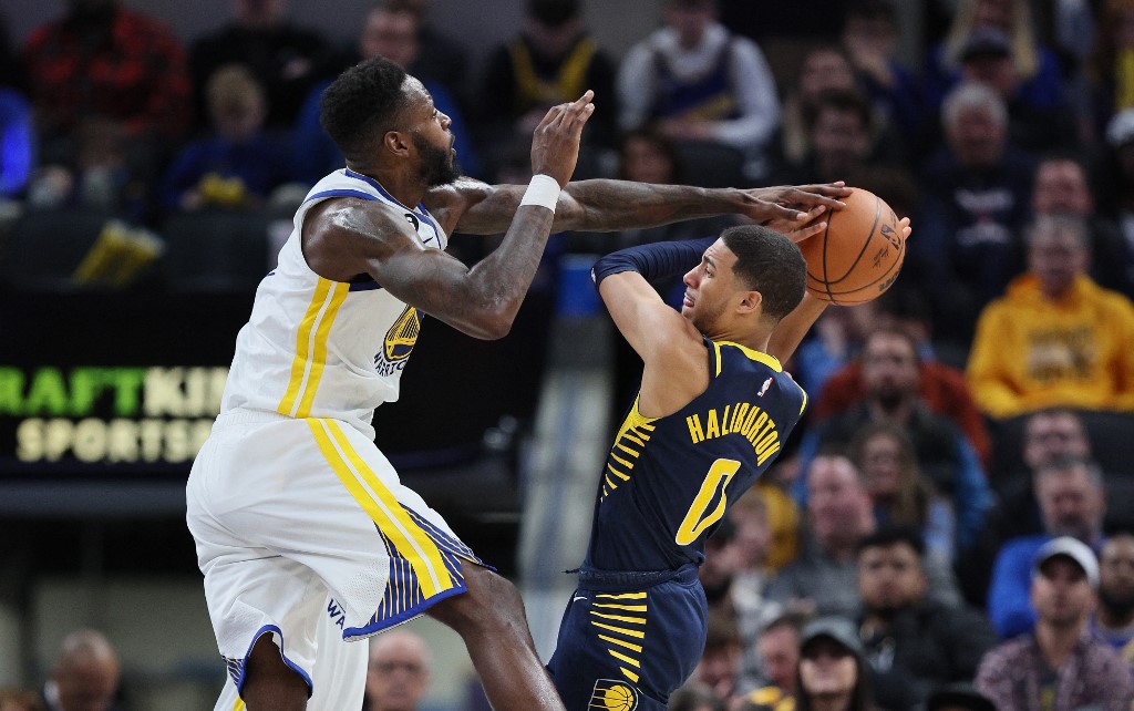  Tyrese Haliburton #0 of the Indiana Pacers shot is blocked by JaMychal Green #1 of the Golden State Warriors at Gainbridge Fieldhouse on December 14, 2022 in Indianapolis, Indiana. 