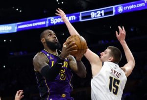 LeBron James #6 of the Los Angeles Lakers takes a shot against Nikola Jokic #15 of the Denver Nuggets in the second half at Crypto.com Arena on December 16, 2022 in Los Angeles, California.