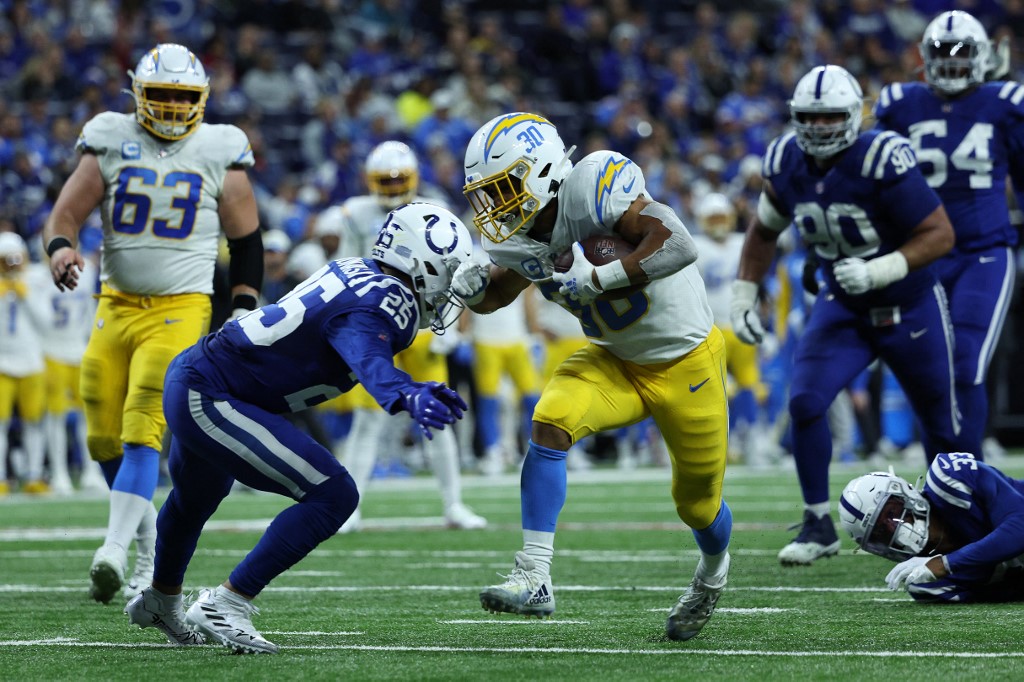     Austin Ekeler #30 of the Los Angeles Chargers scores during a game against the Indianapolis Colts at Lucas Oil Stadium on December 26, 2022 in Indianapolis, Indiana.