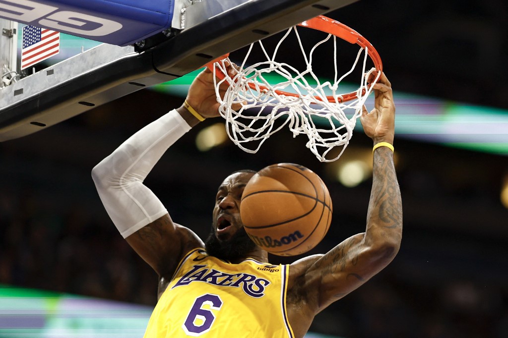  LeBron James #6 of the Los Angeles Lakers slams the ball against the Orlando Magic during the third quarter at Amway Center on December 27, 2022 in Orlando, Florida. 