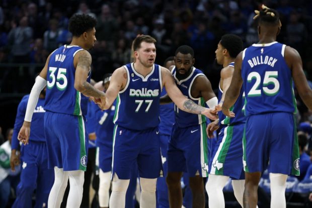  Luka Doncic #77 of the Dallas Mavericks talks with his teammates during a timeout in the second half against the New York Knicks at American Airlines Center on December 27, 2022 in Dallas, Texas.