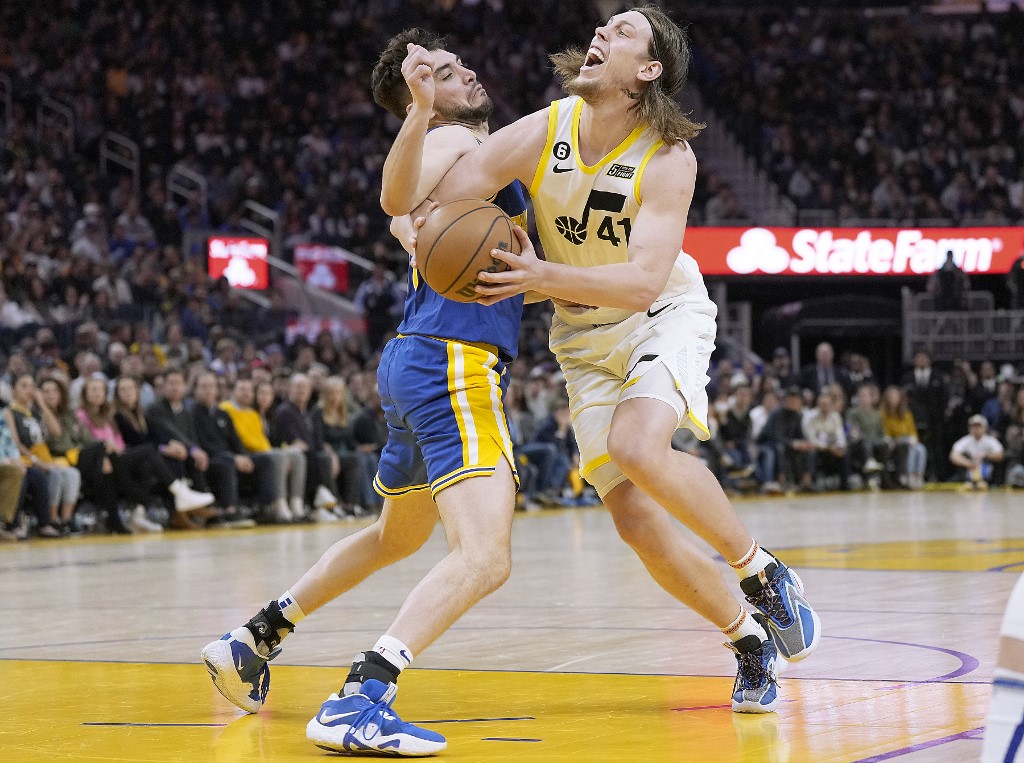  Kelly Olynyk #41 of the Utah Jazz gets fouled by Ty Jerome #10 of the Golden State Warriors driving to the basket during the fourth quarter at Chase Center on December 28, 2022 in San Francisco, California. 
