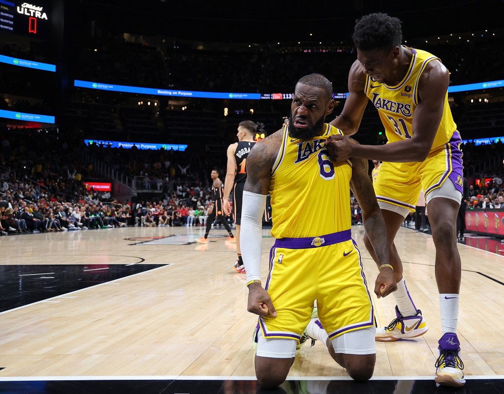     LeBron James #6 of the Los Angeles Lakers reacts to Thomas Bryant #31 after fouling the basket against the Atlanta Hawks during the fourth round at State Farm Arena on December 30, 2022 in Atlanta, Georgia.