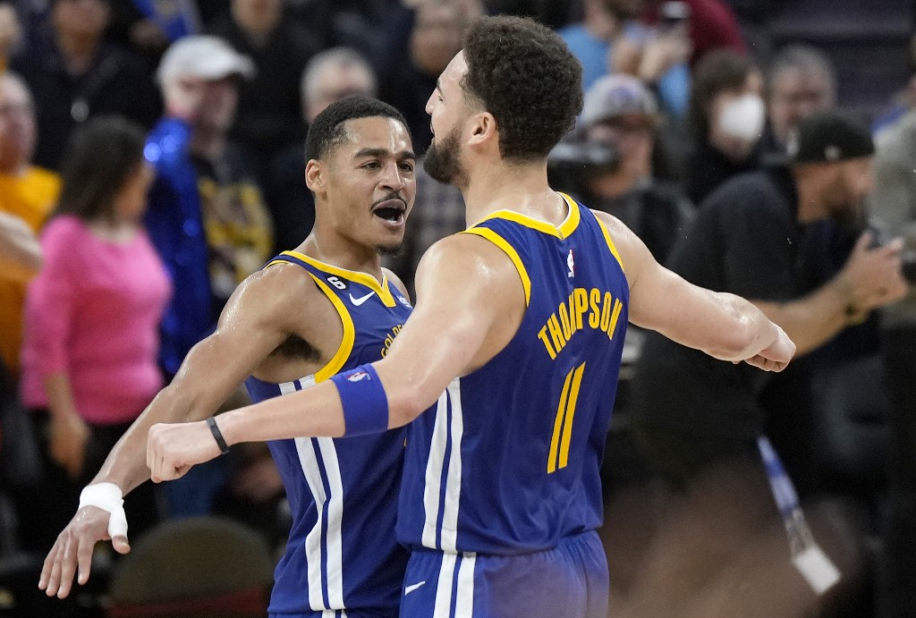  Jordan Poole #3 and Klay Thompson #11 of the Golden State Warriors celebrates after they defeated the the Portland Trail Blazers 118-112 at Chase Center on December 30, 2022 in San Francisco, California. 
