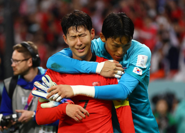 Soccer Football - FIFA World Cup Qatar 2022 - Group H - South Korea v Portugal - Education City Stadium, Al Rayyan, Qatar - December 2, 2022  South Korea's Son Heung-min and Kim Seung-gyu celebrate after the match as South Korea qualify for the knockout stages 