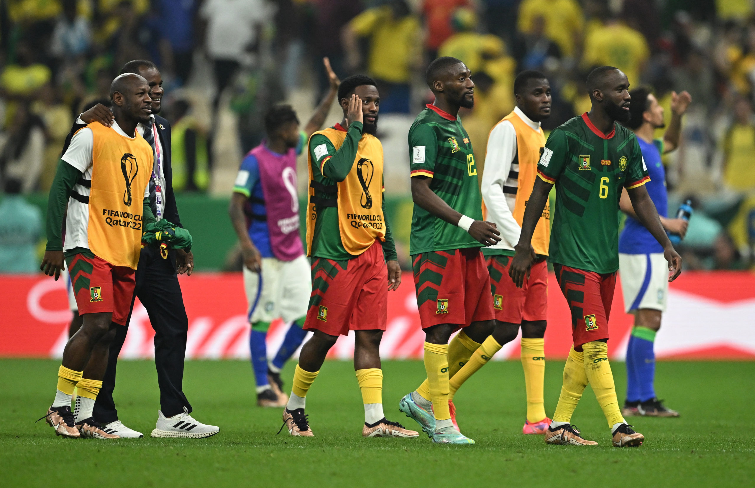 Soccer Football - FIFA World Cup Qatar 2022 - Group G - Cameroon v Brazil - Lusail Stadium, Lusail, Qatar - December 2, 2022 Cameroon's Nicolas Moumi Ngamaleu with teammates look dejected as Cameroon are eliminated from the World Cup 
