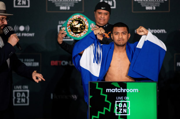 Nicaragua's boxer Roman "Chocolatito" Gonzalez is cloaked in a Nicaraguan flag during a weigh-in ahead of his boxing bout against Juan Francisco Estrada in Glendale, Arizona, U.S., December 2, 2022. 