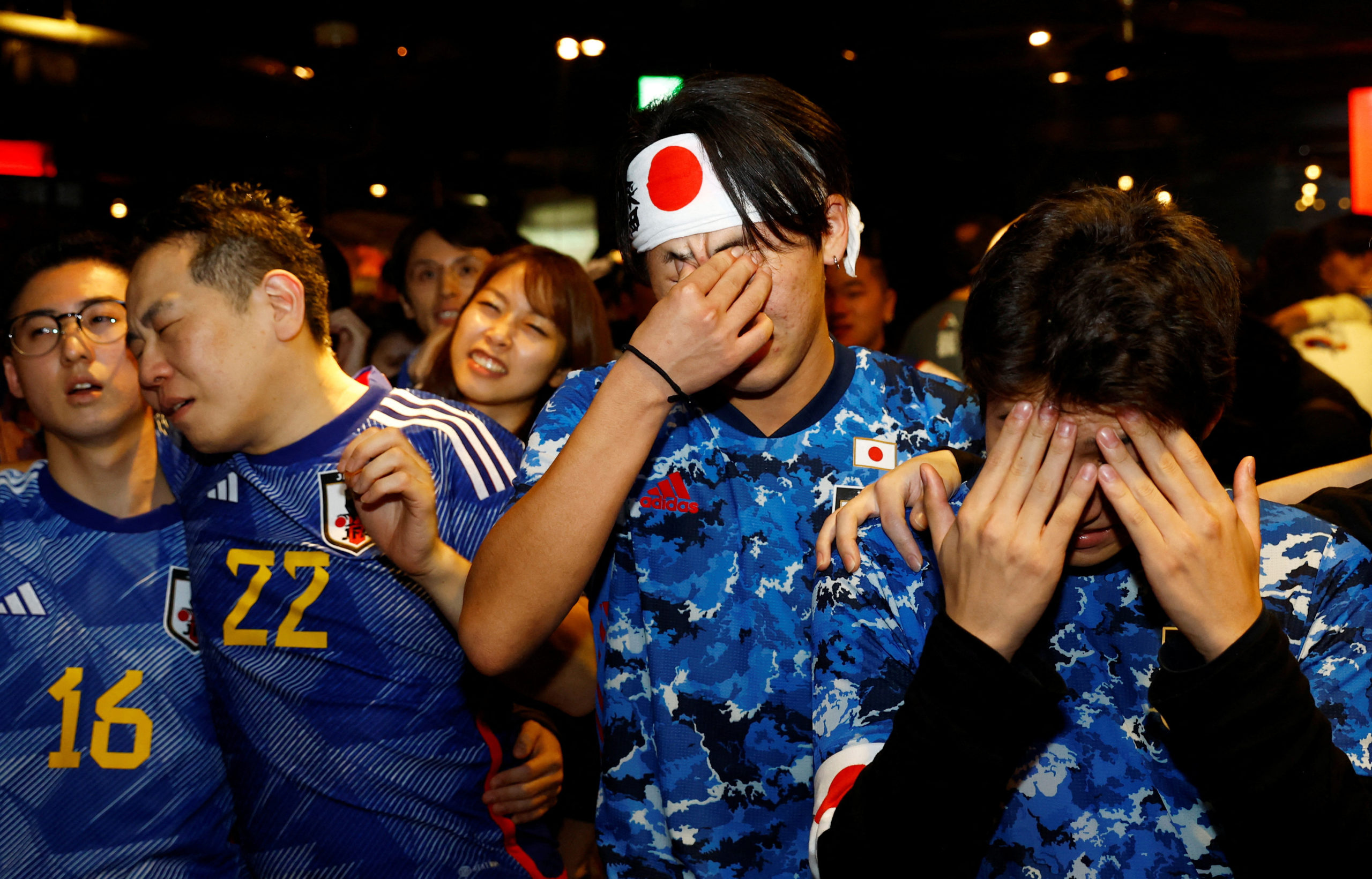 all - FIFA World Cup Qatar 2022 - Fans in Tokyo watch Japan v Croatia - Tokyo, Japan - December 6, 2022  Japan fans react as they watch the penalty shootout at the Bee bar 