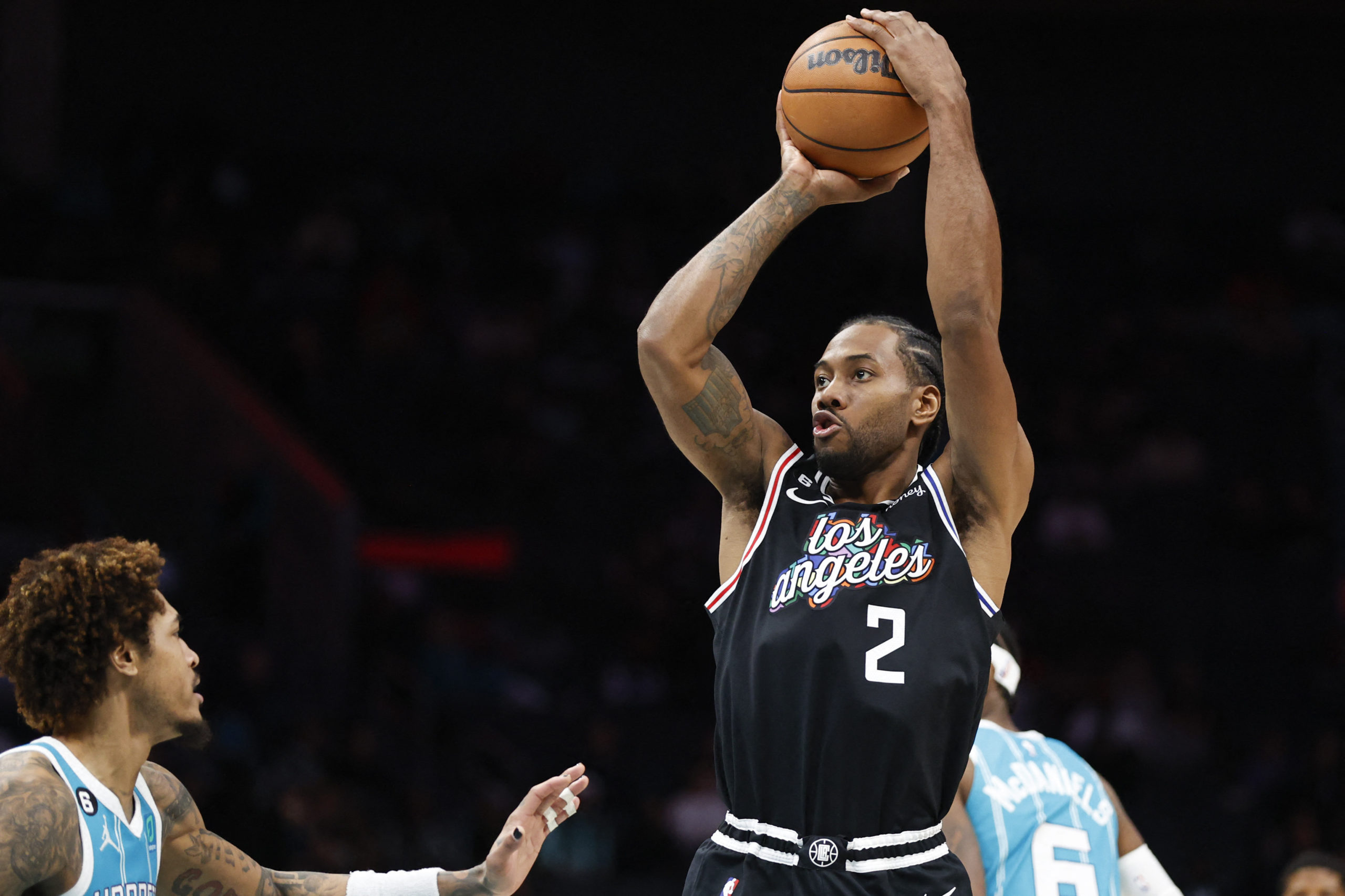 Dec 5, 2022; Charlotte, North Carolina, USA; Los Angeles Clippers forward Kawhi Leonard (2) shoots over Charlotte Hornets guard Kelly Oubre Jr. (12) during the second half at Spectrum Center. The Los Angeles Clippers won 119-117. at Spectrum Center. 