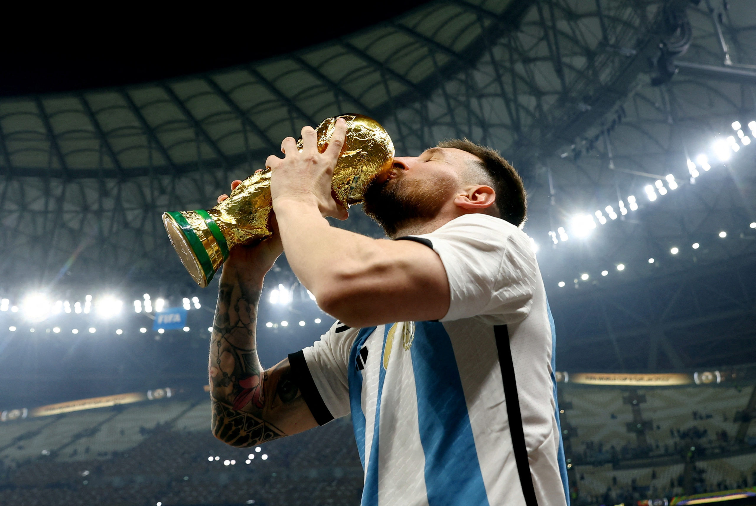 Lionel Messi Kisses His Trophy While Celebrating Win at FIFA World