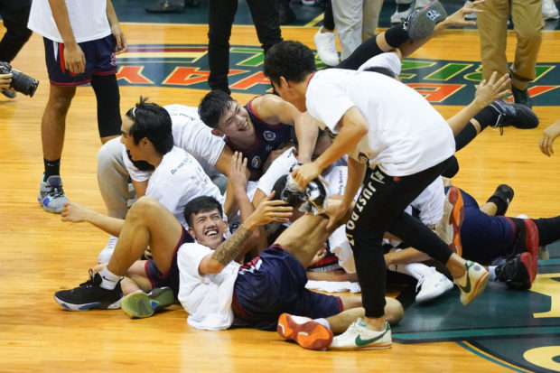 The Winning Knights celebrate at center court after finishing the Blazers, 2-1, in the NCAA Finals for the school's first peat third since 1984. —AUGUST DELA CRUZ