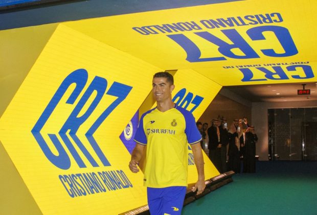 A handout picture released by Saudi Arabia's al-Nassr football club shows Al-Nassr's new Portuguese forward Cristiano Ronaldo entering the pitch during his unveiling ceremony at the Mrsool Park Stadium in the Saudi capital Riyadh on January 3, 2023.