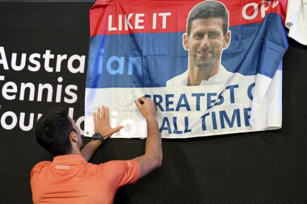 Serbia's Novak Djokovic signs autographs after his Arena Showdown charity match ahead of the Australian Open tennis tournament in Melbourne on January 13, 2023. 