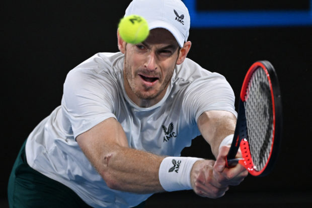 Britain's Andy Murray hits a return against Australia's Thanasi Kokkinakis during their men's singles match on day four of the Australian Open tennis tournament in Melbourne on January 20, 2023. (Photo by WILLIAM WEST / AFP) / -- IMAGE RESTRICTED TO EDITORIAL USE - STRICTLY NO COMMERCIAL USE --
