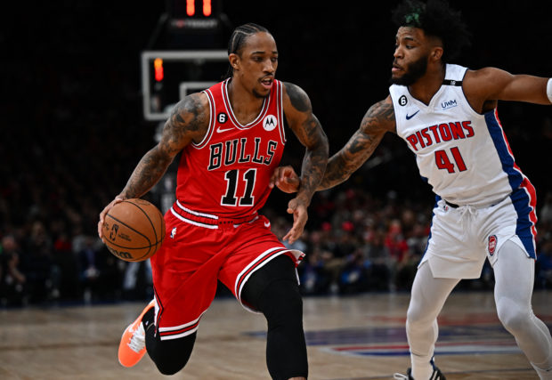 Chicago Bulls' US' power forward DeMar Derozan fights against Detroit Pistons' US' forward Saddiq Bey during the 2023 NBA Paris Games basketball match between Detroit Bulls and Chicago Pistons at the Arena stadium in Paris on January 19, 2023. (Photo by Anne-Christine POUJOULAT / AFP