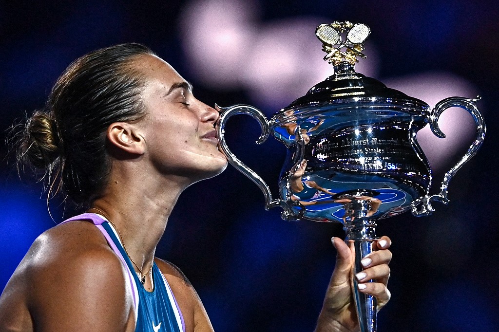 Belarus' Aryna Sabalenka celebrates with the Daphne Akhurst Memorial Cup after defeating Kazakhstan's Elena Rybakina in the women's singles final match on day thirteen of the Australian Open tennis tournament in Melbourne on January 28, 2023. 
