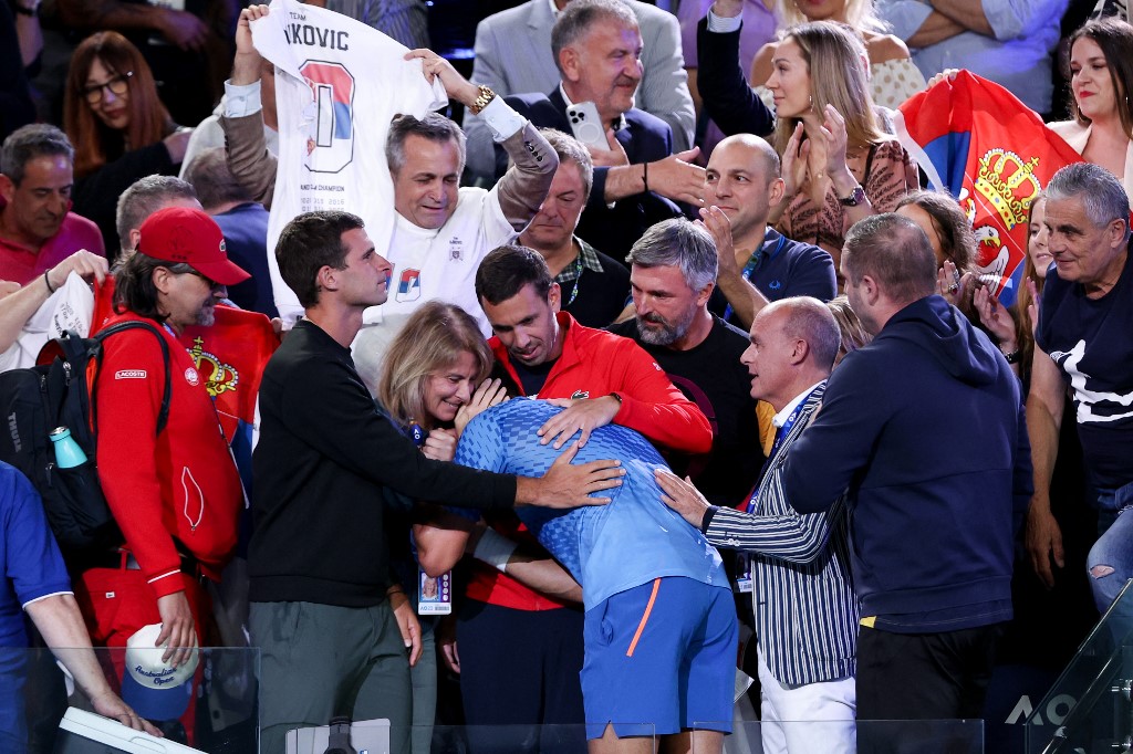 Serbia's Novak Djokovic (C) celebrates with his mother Dijana Djokovic (centre L) after victory against Greece's Stefanos Tsitsipas during their men's singles final against on day fourteen of the Australian Open tennis tournament in Melbourne on January 29, 2023