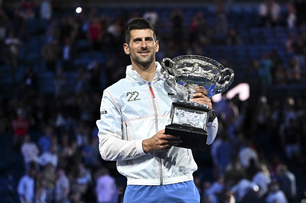 Serbia's Novak Djokovic poses with the Norman Brookes Challenge Cup trophy following his victory against Greece's Stefanos Tsitsipas in the men's singles final match on day fourteen of the Australian Open tennis tournament in Melbourne on January 29, 2023. 