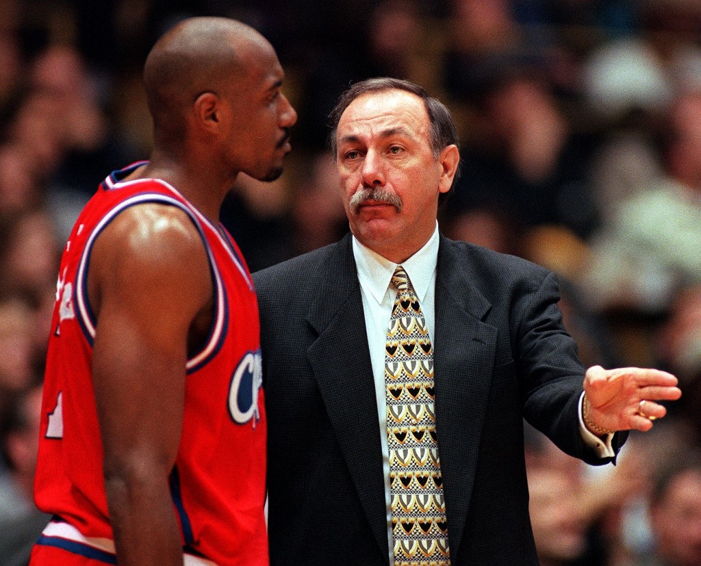 Los Angeles Clippers head coach Chris Ford (R) talks to player Tyron Nasby during a game against the Los Angeles Lakers on March 10, 1999 in Los Angeles, CA.