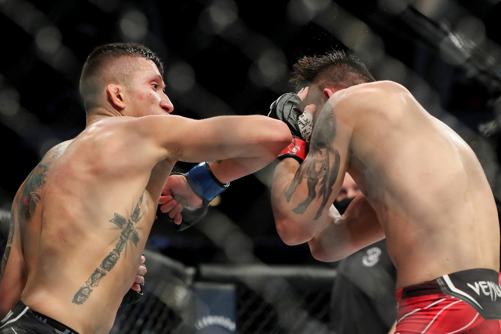 Aoriqileng of China gets caught with an elbow from Jeffrey Molina of the United States during UFC 261 at VyStar Veterans Memorial Arena on April 24, 2021 in Jacksonville, Florida. 