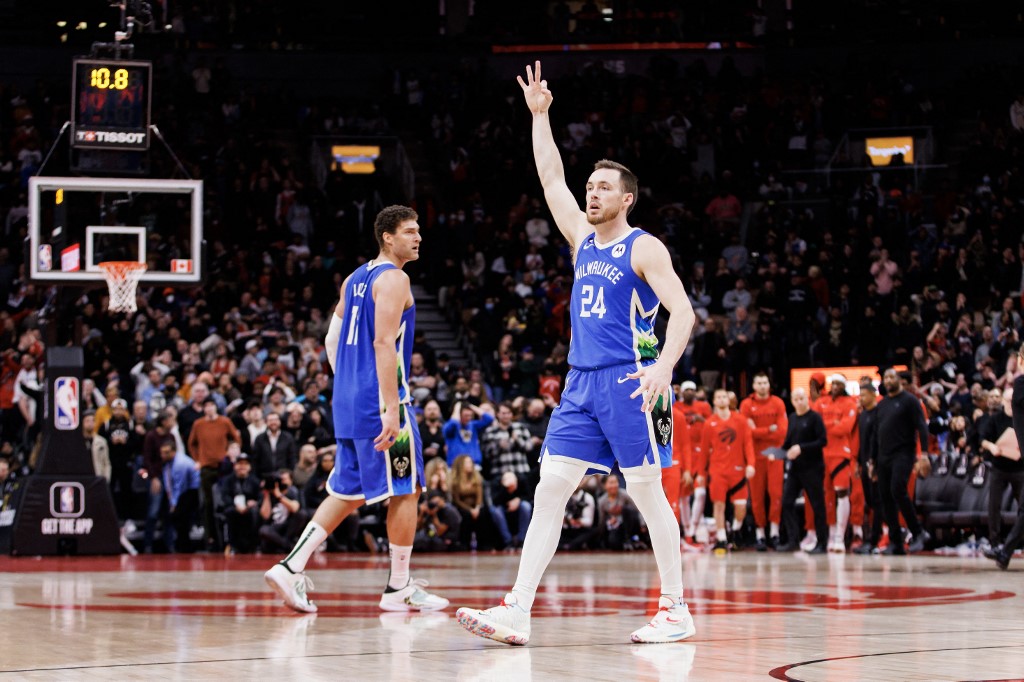 Pat Connaughton #24 of the Milwaukee Bucks celebrates a basket by Grayson Allen #12 in the final moments of overtime in their NBA game against the Toronto Raptors at Scotiabank Arena on January 4, 