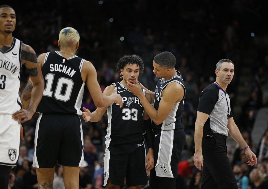 Tre Jones #33 of the San Antonio Spurs is checked by Keldon Johnson #3 of the San Antonio Spurs after being fouled by the Brooklyn Nets in the second half at AT&T Center on January 17, 2023 in San Antonio, Texas. 