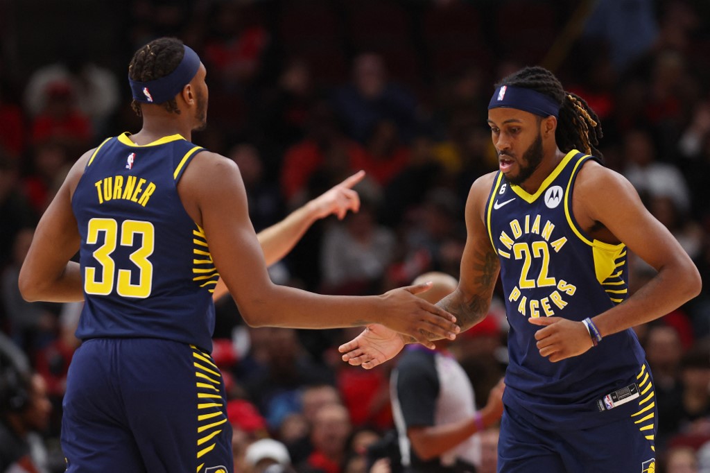 : Myles Turner #33 of the Indiana Pacers high fives Isaiah Jackson #22 against the Chicago Bulls during the first half at United Center on October 26, 2022 in Chicago, Illinois.