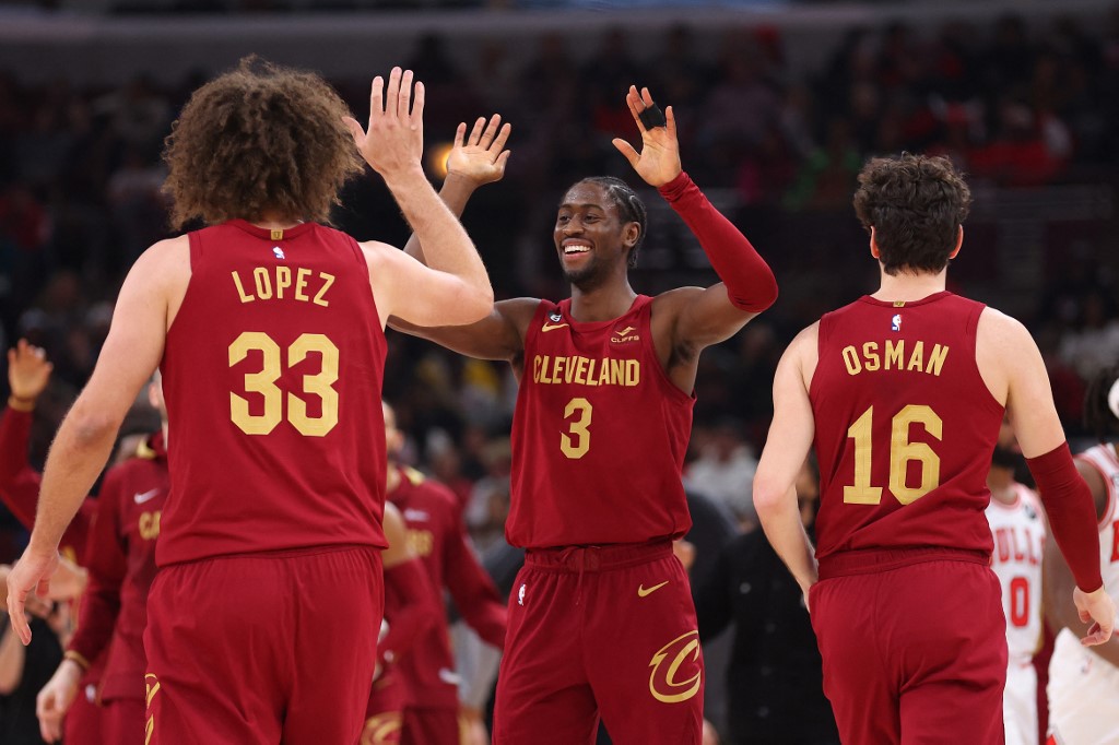 Caris LeVert #3 of the Cleveland Cavaliers celebrates with Robin Lopez #33 and Cedi Osman #16 against the Chicago Bulls during the first half at United Center on December 31, 2022 in Chicago, Illinois