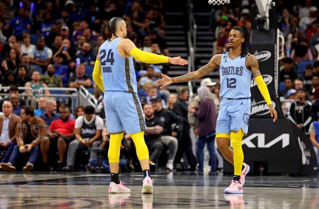 Ja Morant #12 and Dillon Brooks #24 of the Memphis Grizzlies high five during a game against the Orlando Magic at Amway Center on January 05, 2023 in Orlando, Florida. Mike Ehrmann/Getty Images/AFP NOTE TO USER: User expressly acknowledges and agrees that, by downloading and or using this photograph, User is consenting to the terms and conditions of the Getty Images License Agreement.