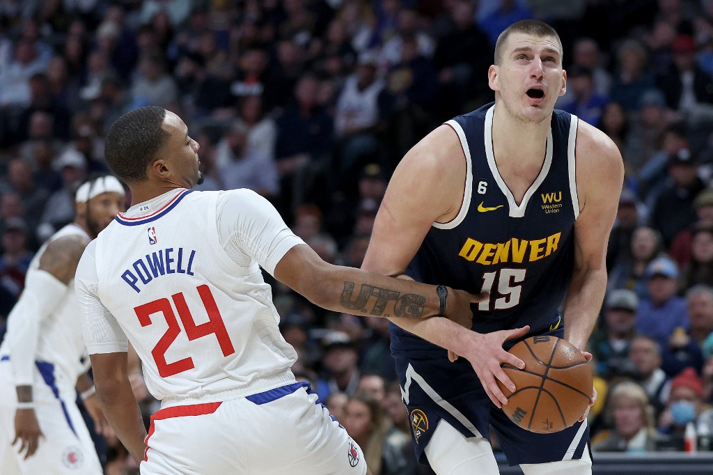  Nikola Jokic #15 of the Denver Nuggets is fouled going to the basket by Norman Powell #24 of the Los Angeles Clippers in the first quarter at Ball Arena on January 05, 2023 in Denver, Colorado.