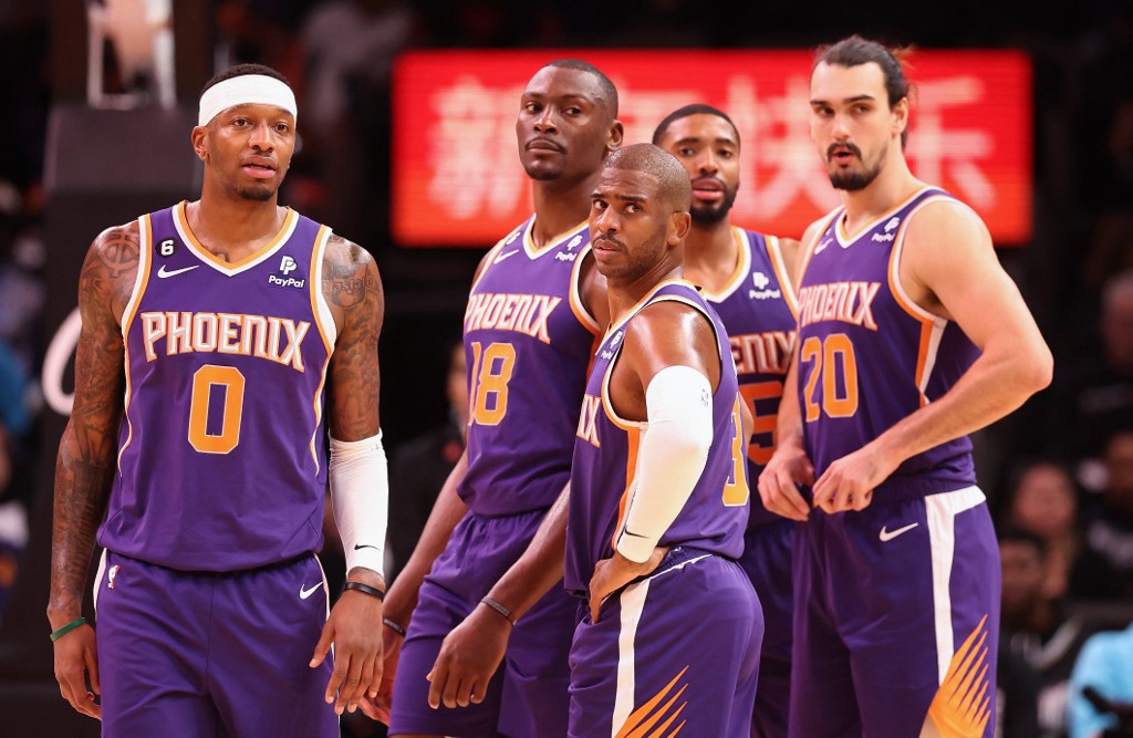 FILE–Torrey Craig #0, Bismack Biyombo #18, Chris Paul #3, Mikal Bridges #25 and Dario Saric #20 of the Phoenix Suns stand on the field during the first half of an NBA game against the Memphis Grizzlies at Center Mark foot on January 22, 2023 in Phoenix, Arizona.