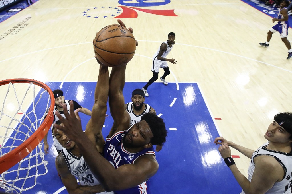 Nic Claxton #33 of the Brooklyn Nets blocks Joel Embiid #21 of the Philadelphia 76ers during the first quarter at Wells Fargo Center on January 25, 2023 in Philadelphia, Pennsylvania.