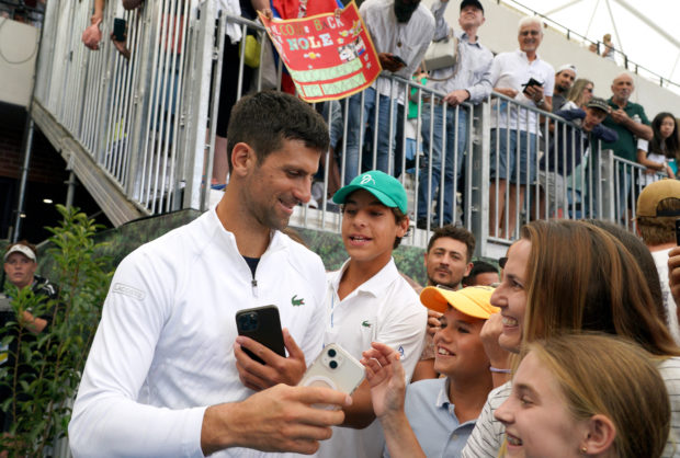Tennis - Adelaide International - Memorial Drive Tennis Club, Adelaide, Australia - January 3, 2023 Serbia's Novak Djokovic with fans after winning his first round match against France's Constant Lestienne 
