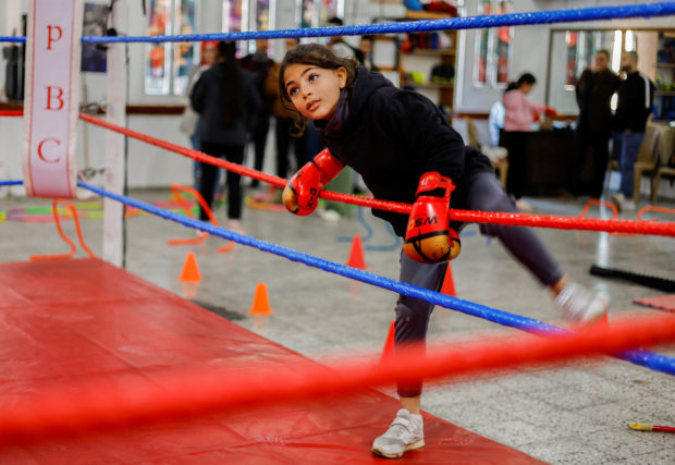 Lamees Abu Al-Qomsan, a 9-year-old girl boxer, warms up during training inside the first women boxing center in Gaza City January 17, 2023. 
