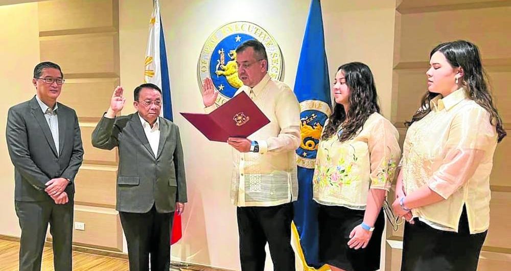 Dickie Bachmann (middle) takes his oath before Executive Secretary Lucas Bersamin (second from left) at Malacañang. Standing beside Bersamin is Deputy Executive Secretary Hubert Guevarra (left).