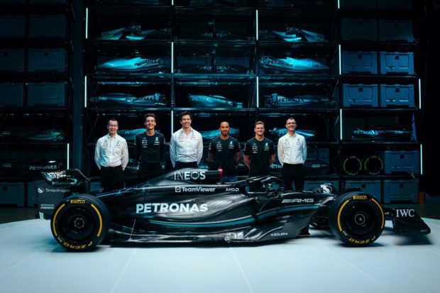 A handout image released by Mercedes shows the team's British driver George Russell (2L), Team principal Toto Wolff (3L), British driver Lewis Hamilton (3R) and reserve driver German driver Mick Schumacher (2R) posing with their new Mercedes-AMG F1 W14 E Formula One racing car during their 2023 season launch, in Silverstone on February 15, 2023. 