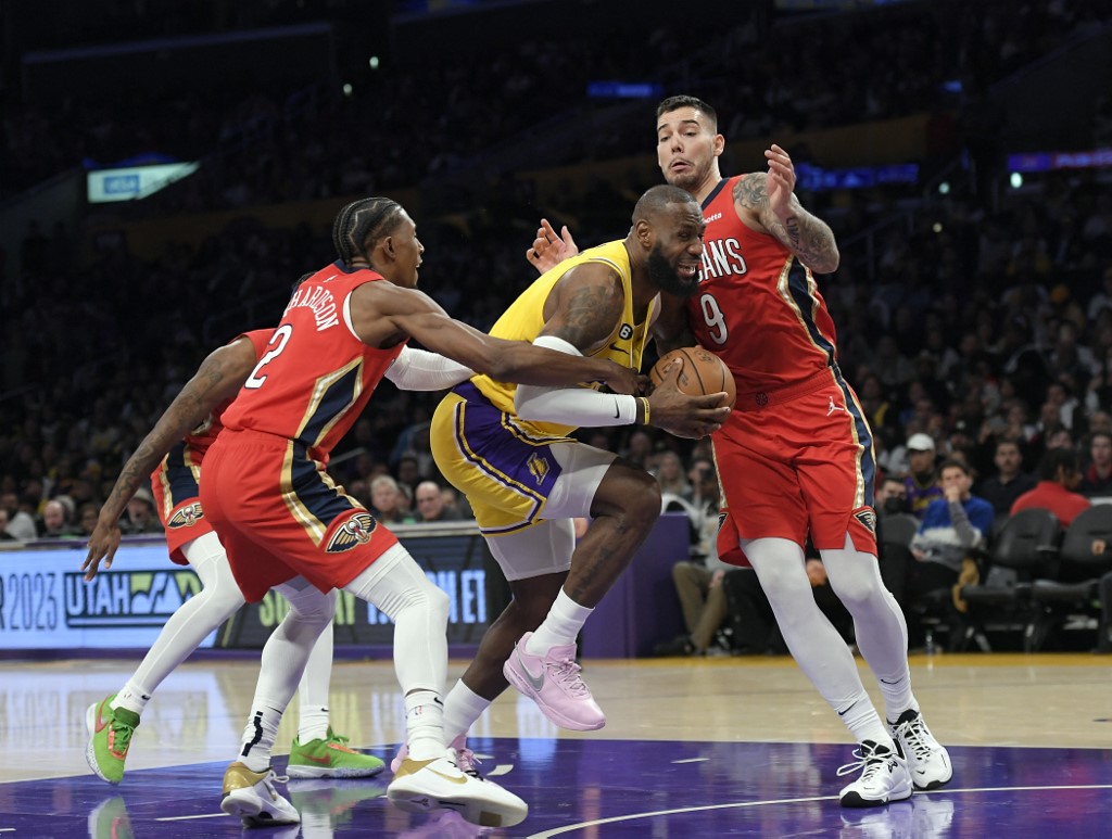  LeBron James #6 of the Los Angeles Lakers is fouled by Josh Richardson #2 of the New Orleans Pelicans as Willy Hernangomez #9 of the Pelicans defends in the first half at Crypto.com Arena on February 15, 2023 in Los Angeles, California. 
