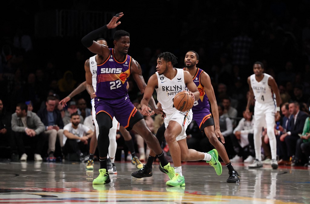 Cam Thomas #24 of the Brooklyn Nets drives against Deandre Ayton #22 of the Phoenix Suns during their game at Barclays Center on February 07, 2023 in New York City. 