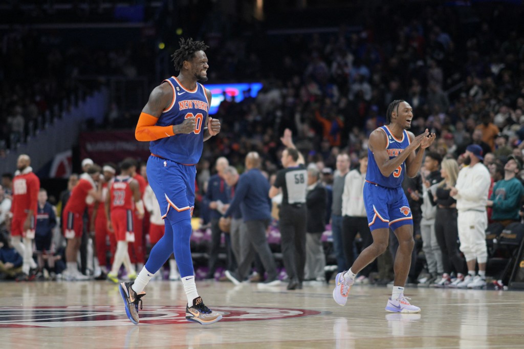  Julius Randle #30 and Immanuel Quickley #5 of the New York Knicks react after their team scores against the Washington Wizards before a timeout in the second half at Capital One Arena on February 24, 2023 in Washington, DC.