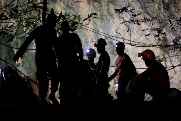 FILE PHOTO: Rescuers rest as they remove machines after 12 soccer players and their coach were rescued at the Tham Luang cave complex in the northern province of Chiang Rai, Thailand, July 10, 2018. 