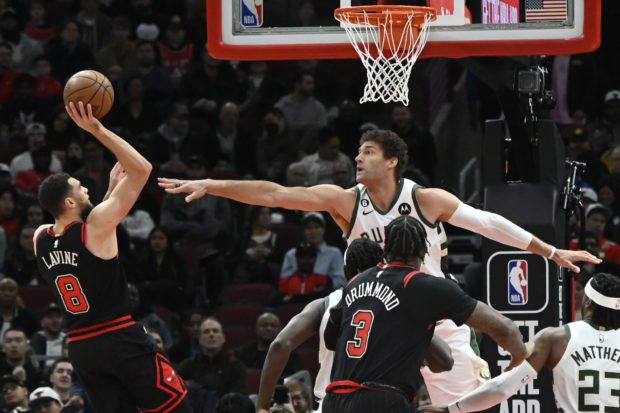Feb 16, 2023; Chicago, Illinois, USA;  Chicago Bulls guard Zach LaVine (8) shoots against Milwaukee Bucks center Brook Lopez (11) during the first half at the United Center. 