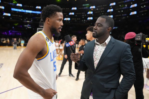 Feb 23, 2023; Los Angeles, California, USA; TNT reporter Chris Haynes (right) interviews Los Angeles Lakers guard Malik Beasley (5) after the game against the Golden State Warriors at Crypto.com Arena.