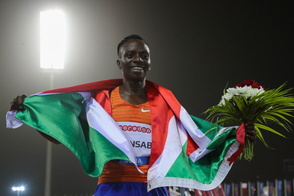 Burundi's Francine Niyonsaba celebrates winning the women's 3000m event during the IAAF Diamond League athletics Doha meeting at the Khalifa International stadium in the Qatar capital on May 13, 2022. (Photo by KARIM JAAFAR / AFP)