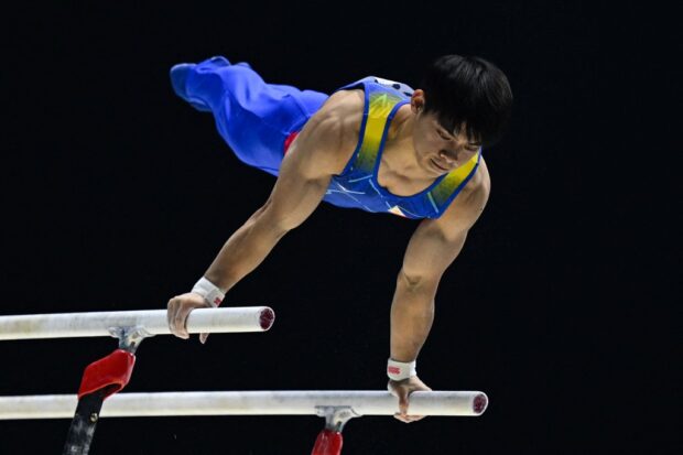 FILE - The Philippines' Carlos Edriel Yulo competes during the Men's Parallel Bars final at the World Gymnastics Championships in Liverpool, northern England on November 6, 2022. (Photo by Paul ELLIS / AFP) /