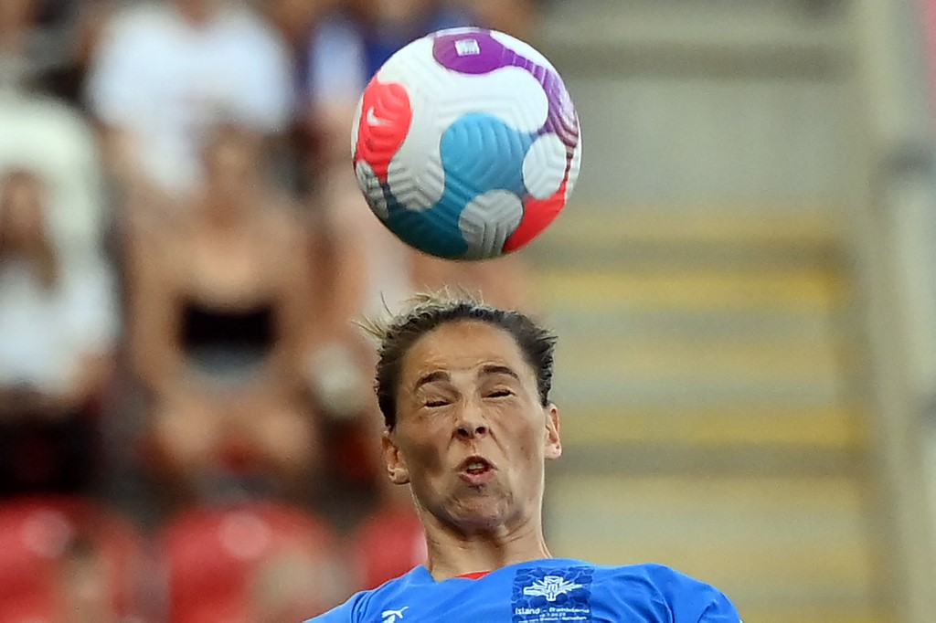 (FILES) In this file photo taken on July 18, 2022, Iceland midfielder Sarah Björk Gunnarsdottir heads the ball during the UEFA Women's Euro 2022 Group D football match between Iceland and France at York Stadium in Rotherham, northern England.  (Photo by FRANCK FIFE / AFP) / Not for use as moving pictures or quasi-video streaming.  Therefore photos should be posted at least 20 seconds apart.