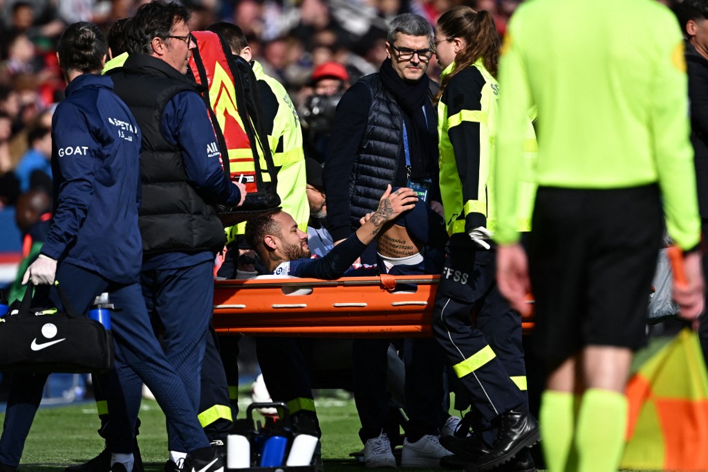 (FILES) In this file photo taken on February 19, 2023 Paris Saint-Germain's Brazilian forward Neymar (C) is stretched out during the French L1 football match between Paris Saint-Germain (PSG) and Lille LOSC at The Parc des Princes Stadium in Paris