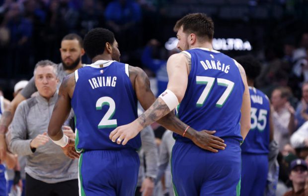 DALLAS, TX - MARCH 2: Kyrie Irving #2 and teammate Luka Doncic #77 of the Dallas Mavericks celebrate against the Philadelphia 76ers in the second half at American Airlines Center on March 2, 2023 in Dallas, Texas. The Mavericks won 133-126. NOTE TO USER: User expressly acknowledges and agrees that, by downloading and or using this photograph, User is consenting to the terms and conditions of the Getty Images License Agreement. Ron Jenkins/Getty Images/AFP (Photo by Ron Jenkins / GETTY IMAGES NORTH AMERICA / Getty Images via AFP)